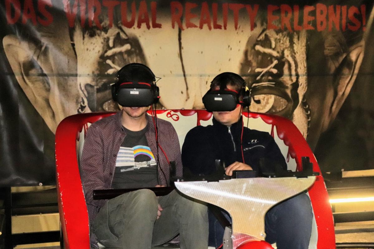 fun ride car with two people in it wearing VR headsets