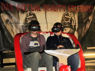 fun ride car with two people in it wearing VR headsets